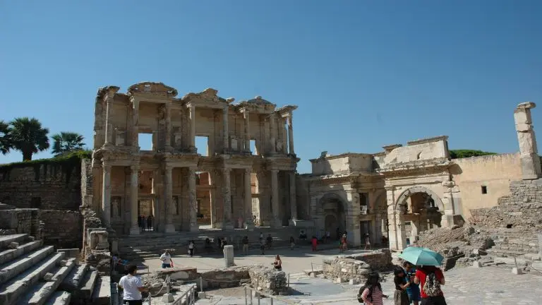 A view of Celsus library in Ephesus antique site. Tourists visiting Celsus library in a hot day