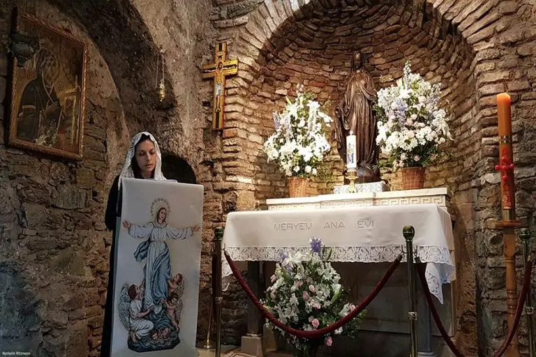 A non holds Virgin Mary picture in the church of Virgin Mary at Biblical Ephesus Tour